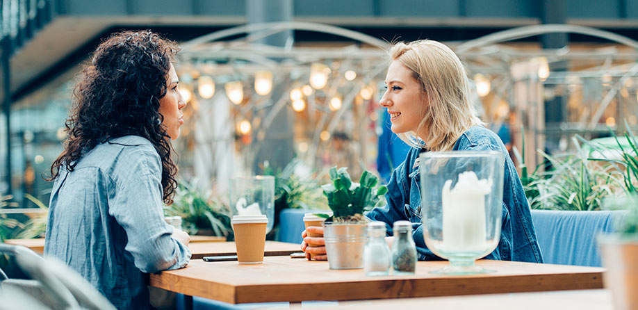 Two women enjoying coffee and speaking
